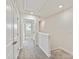 Well-lit hallway with neutral carpet and white doors, providing a clean and open feel at 2610 Greenmarket Dr, Charlotte, NC 28217