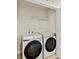 Convenient laundry room area with Samsung washer and dryer, and ample shelving for storage at 2610 Greenmarket Dr, Charlotte, NC 28217