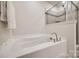 Close-up of a bathtub and shower combo featuring neutral colors and tiling at 2635 Winter Thistle Way, Indian Land, SC 29707