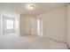 Bright carpeted bedroom with a window and white closet doors at 2635 Winter Thistle Way, Indian Land, SC 29707