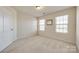 Bedroom with carpet, two windows, and a closet at 2635 Winter Thistle Way, Indian Land, SC 29707