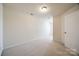 Bright bedroom with neutral carpet, a ceiling light, and a white door at 2635 Winter Thistle Way, Indian Land, SC 29707