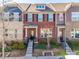Charming brick townhome featuring neat landscaping, black shutters, and a welcoming front porch at 2635 Winter Thistle Way, Indian Land, SC 29707