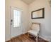 Bright front foyer features stylish flooring, a decorative mirror, and a comfortable accent chair at 2635 Winter Thistle Way, Indian Land, SC 29707