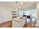 Bright kitchen featuring granite countertops, an island with seating, and seamless transition to the living space at 2635 Winter Thistle Way, Indian Land, SC 29707