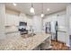 Modern kitchen with white cabinetry, stainless steel appliances, granite countertops, and pendant lighting at 2635 Winter Thistle Way, Indian Land, SC 29707
