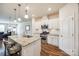 Open-concept kitchen featuring an island, stainless steel appliances, and views into the living area at 2635 Winter Thistle Way, Indian Land, SC 29707