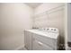 Bright laundry room with washer, dryer, and overhead shelving for ample storage space at 2635 Winter Thistle Way, Indian Land, SC 29707