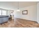 Bright living room with wood floors and a decorative mirror on the wall at 2635 Winter Thistle Way, Indian Land, SC 29707