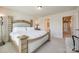 Main bedroom featuring a bed, neutral colors and a glimpse into an ensuite at 2635 Winter Thistle Way, Indian Land, SC 29707