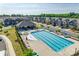 Community pool view with seating and covered pavilion, with neighborhood townhomes in the background at 2635 Winter Thistle Way, Indian Land, SC 29707