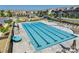 Community pool with sunning deck, lounge chairs, umbrellas, and a fountain feature in a townhome community at 2635 Winter Thistle Way, Indian Land, SC 29707
