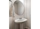 Contemporary powder room featuring a pedestal sink, oval mirror, and modern fixtures at 2635 Winter Thistle Way, Indian Land, SC 29707