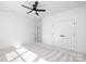 Bedroom with modern ceiling fan, plush carpeting, and convenient closet access, providing comfort and style at 302 Lincoln St, Belmont, NC 28012