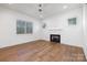 Bright bedroom with a fireplace, hardwood floors, and large windows providing natural light at 302 Lincoln St, Belmont, NC 28012