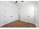 Bedroom with hardwood floors, ceiling fan, and multiple closets, offering ample storage space at 302 Lincoln St, Belmont, NC 28012