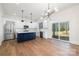 Bright kitchen open to the dining area, featuring stainless appliances, and a large island with wood flooring at 302 Lincoln St, Belmont, NC 28012