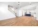 Bright living area with hardwood floors connecting the staircase, kitchen, and other rooms at 302 Lincoln St, Belmont, NC 28012