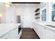 Bright kitchen featuring stainless appliances, custom white cabinetry, quartz counters and an island at 3115 Pinehurst Pl, Charlotte, NC 28209