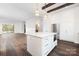 Open concept kitchen with a large island, stainless steel appliances, and hardwood floors throughout the house at 3115 Pinehurst Pl, Charlotte, NC 28209