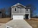 Charming two-story home featuring a gray exterior, white garage door, and well-manicured lawn at 313 Alden Ct, Shelby, NC 28152