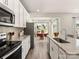 Modern kitchen showcasing white cabinets, granite countertops, stainless steel appliances, and an open layout at 313 Alden Ct, Shelby, NC 28152