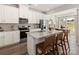 Stylish kitchen with a large island, bar seating, granite countertops, white cabinets, and stainless appliances at 313 Alden Ct, Shelby, NC 28152