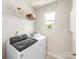 Well-organized laundry room features modern appliances and shelving for convenient storage at 313 Alden Ct, Shelby, NC 28152