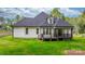 Backyard view of a home featuring a wooden deck and lush greenery at 3732 Whitney Ne Dr, Hickory, NC 28601