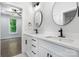 Bright bathroom featuring double vanity, modern fixtures, and sleek mirrors for a luxurious feel at 3732 Whitney Ne Dr, Hickory, NC 28601