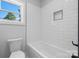 Bathroom with white subway tile backsplash, a tub, and a window looking outside at 3732 Whitney Ne Dr, Hickory, NC 28601