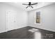 Clean bedroom features a ceiling fan, a window providing natural light, and beautiful dark hardwood floors at 3732 Whitney Ne Dr, Hickory, NC 28601