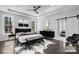 Elegantly staged bedroom with a modern bed, tray ceiling, stylish décor, and natural light from the large windows at 3732 Whitney Ne Dr, Hickory, NC 28601