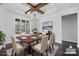 Dining room with modern chandelier, large windows, and hardwood floors at 3732 Whitney Ne Dr, Hickory, NC 28601