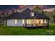 Rear view of a beautiful home with a wooden deck and lush backyard, perfect for entertaining at 3732 Whitney Ne Dr, Hickory, NC 28601
