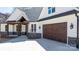 Detailed exterior showcasing stone accents, wooden columns, and a brown garage door at 3732 Whitney Ne Dr, Hickory, NC 28601
