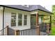 Covered deck area with sliding glass doors and black metal railing at 3732 Whitney Ne Dr, Hickory, NC 28601