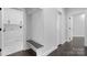 Bright mudroom boasts a built-in bench, convenient storage, and access to the laundry room with white cabinetry at 3732 Whitney Ne Dr, Hickory, NC 28601