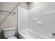 Bright white bathroom features a toilet, shower with tiled walls, and chrome fixtures at 3931 Newhall Nw Dr, Hickory, NC 28601