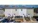 Townhouse back exterior featuring individual patios, rear entrances, and adjacent parking at 3931 Newhall Nw Dr, Hickory, NC 28601