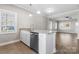 Open-concept kitchen with granite countertops and stainless steel dishwasher flowing into the living area at 3931 Newhall Nw Dr, Hickory, NC 28601