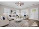 Bright, staged living room with hardwood floors, neutral furniture, and ample natural light at 3931 Newhall Nw Dr, Hickory, NC 28601