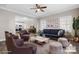 Staged living room featuring a plush blue sofa, elegant decor, and hardwood flooring at 3931 Newhall Nw Dr, Hickory, NC 28601