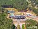 Aerial view of community amenities including a pond with fountain, playground, tennis court, pool and clubhouse at 4354 Persimmon Rd, Lancaster, SC 29720