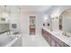 Bright primary bath with marble floors, a glass shower, soaking tub, and double vanities at 4354 Persimmon Rd, Lancaster, SC 29720