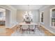 Formal dining room boasting a stylish chandelier, panelled walls, and an area rug under a modern dining set at 4354 Persimmon Rd, Lancaster, SC 29720
