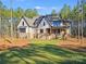 Exterior view of a light home with stone accents, dark shutters, and professional landscaping at 4354 Persimmon Rd, Lancaster, SC 29720