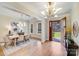 Bright foyer featuring an open door, hardwood floors, statement lighting, and access to the dining room at 4354 Persimmon Rd, Lancaster, SC 29720