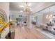 Open concept featuring a foyer with statement lighting, hardwood floors, dining room, and living room at 4354 Persimmon Rd, Lancaster, SC 29720