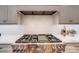 Close-up of range with white cabinets, backsplash and countertops in bright modern kitchen at 4354 Persimmon Rd, Lancaster, SC 29720